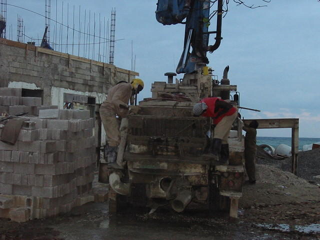 Concrete for the roof slab, quite a task in the heat of the Jamaican sun