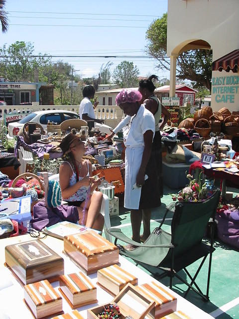 Miss Hilda taking a break from the bar & checking out the goods with some skillfully crafted Jamaican boxes in the foregroun