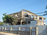View from the street as the roof trusses begin to be fixed